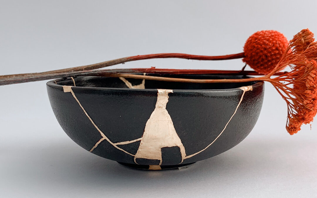 Black bowl repaired using kintsugi